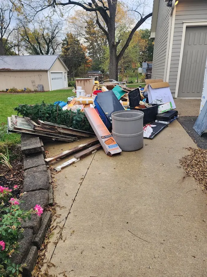 Dumpster being loaded with debris for 12 Yard Dumpster Rental in Jamestown